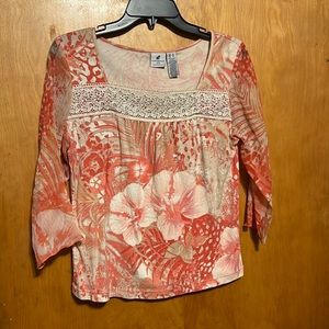 Peachy pink, cream, and tan blouse. With lace over chest and sheer sleeves.